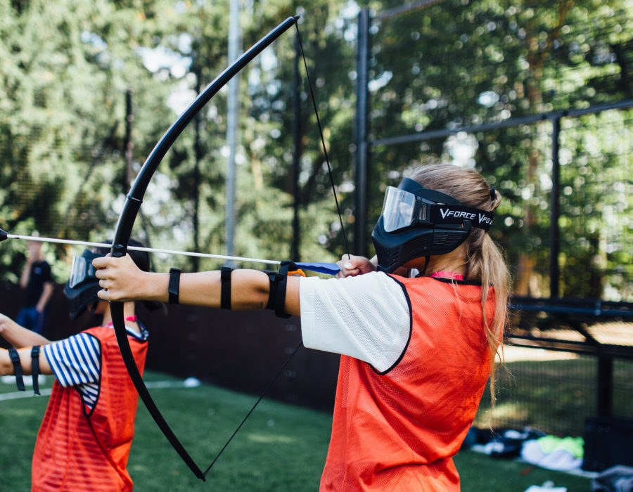 A girl tries archery at Harrow School Summer School